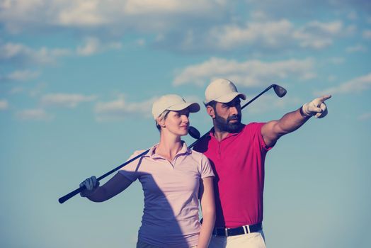 portrait of happy young  couple on golf course