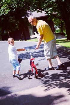 happy grandfather and child have fun and play in park on beautiful  sunny day