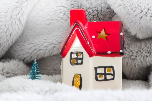 Toy house with red roof, pine tree and snow. New year decoration. Christmas spirit.