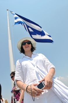 Beautiful young Greek woman in fashion clothes have fun at n the streets of Oia, Santorini, Greece