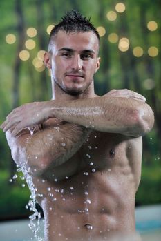 young healthy good looking macho man model athlete at hotel indoor pool