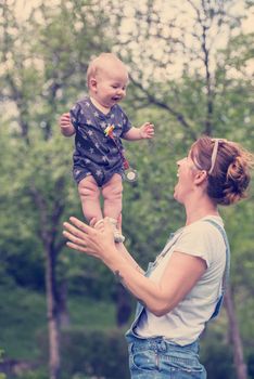 woman with baby have fun in nature