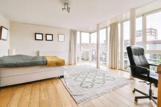 Lovely bedroom with a large bed and a black leather chair