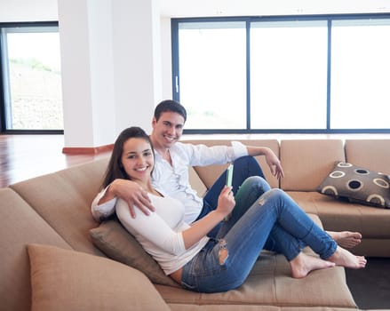 romantic relaxed young couple at modern home using tablet computer