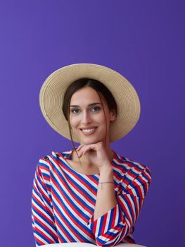 Portrait of young woman sitting on the chair isolated on purple background. Female model in casual and modern clothes posing in the studio