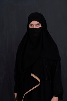 Portrait of muslim woman wearing niqab and traditional arabic clothes or abaya. Arab woman representing modern arabic lifestyle, islamic  fashion and Ramadan kareem concept