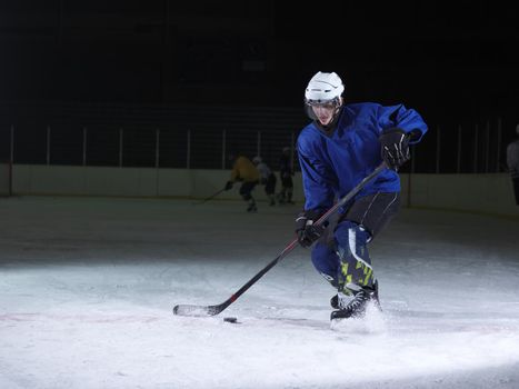 ice hockey player in action kicking with stick