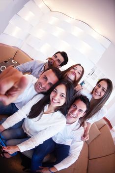 group of friends taking selfie photo with tablet at modern home indoors