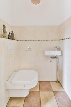 Lovely restroom with small sink and tiled floor