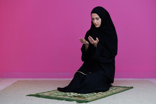 Muslim woman in namaz praying for Allah muslim god. Muslim woman on the carpet praying in traditional middle eastern clothes, Woman in Hijab