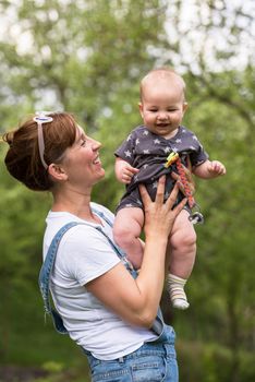 woman with baby have fun in nature