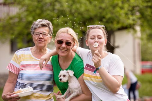 Portrait of grandmother with daughter and granddaughter in park while having fun