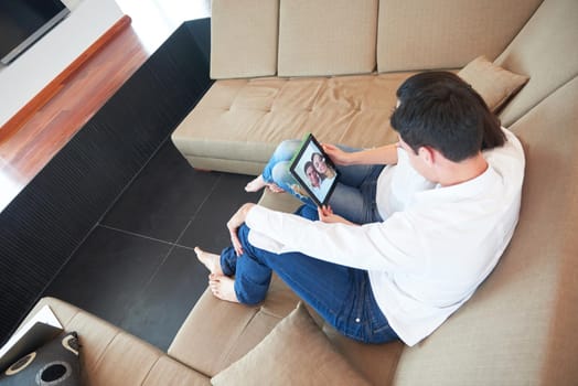 romantic relaxed young couple at modern home using tablet computer