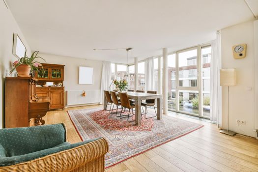 Lovely expansive dining area with large table and large full-length windows