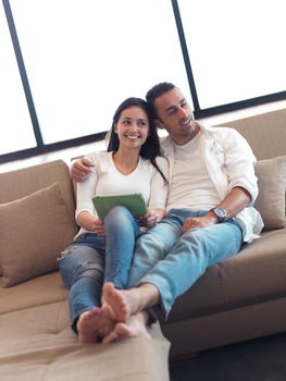 romantic relaxed young couple at modern home using tablet computer