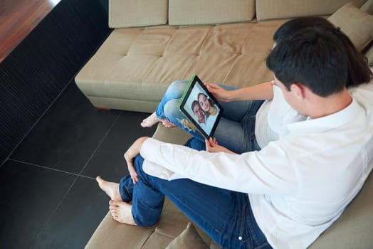 romantic relaxed young couple at modern home using tablet computer