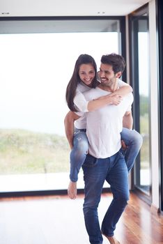 happy young romantic couple have fun relax smile at modern home livingroom interior