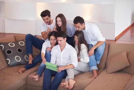 group of friends taking selfie photo with tablet at modern home indoors