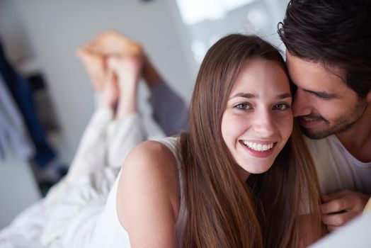 happy young couple relax and have fun in bed