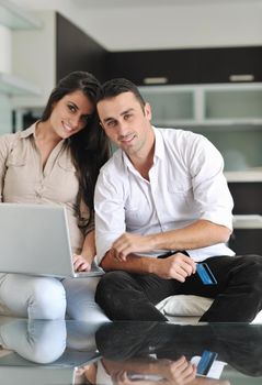 joyful couple relax and work on laptop computer at modern living room indoor home