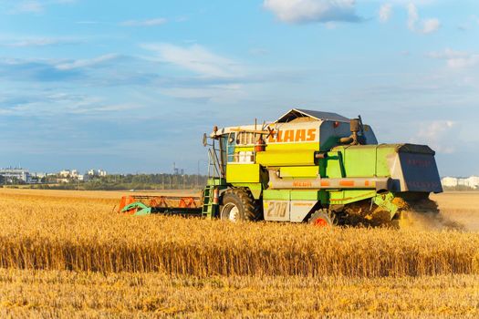 GRODNO, BELARUS - AUG 02: Combine harvester KLAAS working on a wheat field in the neighborhood Olshanka on August 02, 2016 in Grodno, Belarus