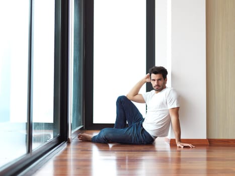 relaxed young man drink first morning coffee at modern home indoors