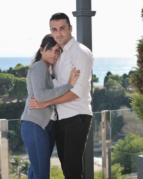 happy young couple in love have romance  relax on balcony outdoor with ocean and blue sky in background