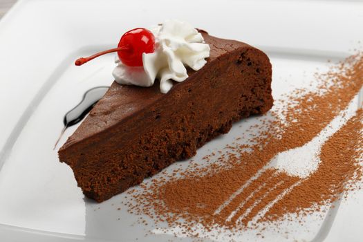 Chocolate cake with white cream served on square plate