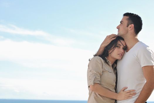 happy young couple in love have romance  relax on balcony outdoor with ocean and blue sky in background