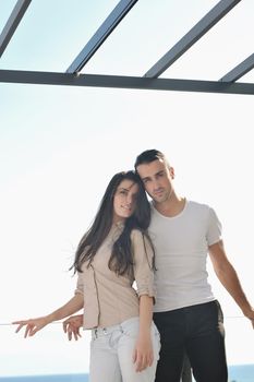 happy young couple in love have romance  relax on balcony outdoor with ocean and blue sky in background