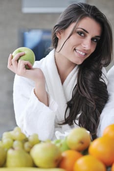 happy young couple have fun in  modern kitchen indoor  while preparing fresh fruits and vegetables food salad