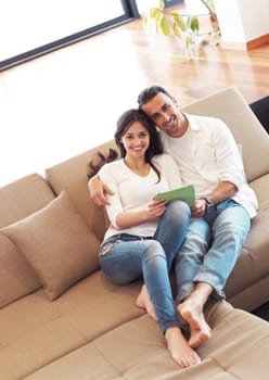 romantic relaxed young couple at modern home using tablet computer