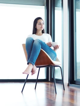 beautiful young woman drink first morning coffee at modern home interior