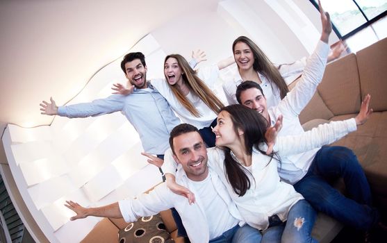 group of friends taking selfie photo with tablet at modern home indoors