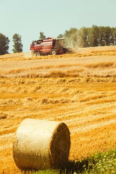 combine harvester working on a wheat field