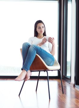 beautiful young woman drink first morning coffee at modern home interior