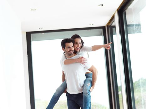 happy young romantic couple have fun relax smile at modern home livingroom indoors