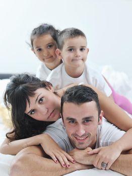 happy young Family in their bedroom have fun and play in bed