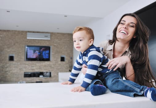 portrait of a happy mom and son together in modern living room home indoor