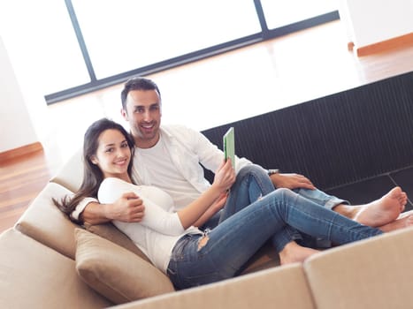 romantic relaxed young couple at modern home using tablet computer