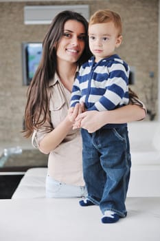 portrait of a happy mom and son together in modern living room home indoor