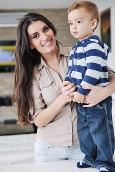 portrait of a happy mom and son together in modern living room home indoor