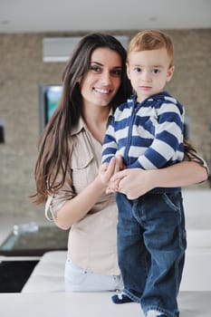 portrait of a happy mom and son together in modern living room home indoor