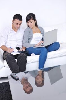 joyful couple relax and work on laptop computer at modern living room indoor home