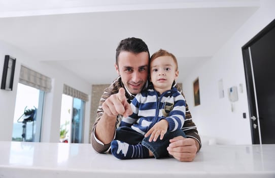 portrait of a happy father and son together in modern living room home indoor