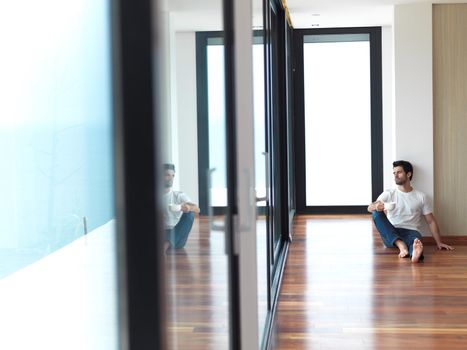 relaxed young man drink first morning coffee at modern home indoors