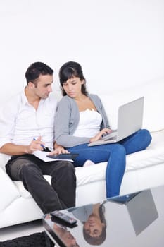 joyful couple relax and work on laptop computer at modern living room indoor home