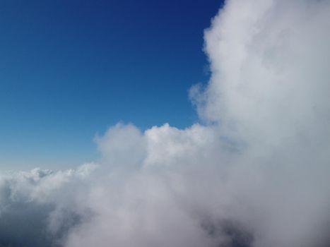 Footage B roll Aerial view drone flying above white clouds dense fog move quickly. Drone flies high back in blue sky through fluffy clouds. Beautiful foggy and cloudy slow moving Aerial view. Fog sea.