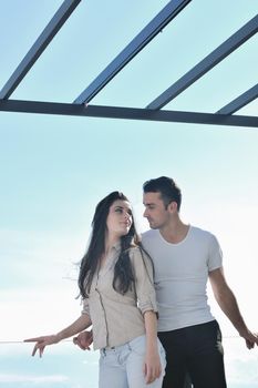 happy young couple in love have romance  relax on balcony outdoor with ocean and blue sky in background