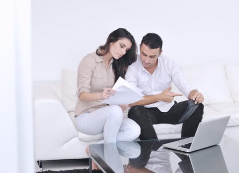 joyful couple relax and work on laptop computer at modern living room indoor home